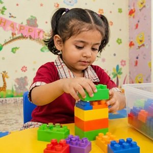 girl playing with colorful building blocks at Tiny Explorer Preschool in Bharuch